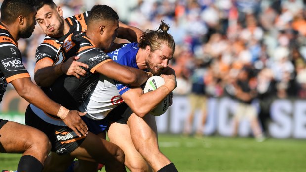 Kieran Foran busts through the Tigers line to almost score a try. 