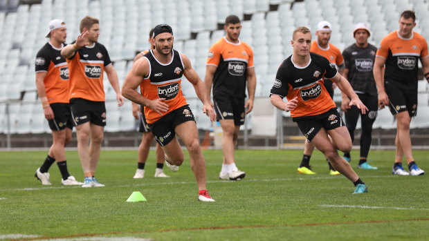 Back in the black, white and orange: Robbie Farah, left, during his first day back at Tigers training. 