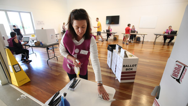 An election official sanitises a polling booth during the Brisbane council election in March.