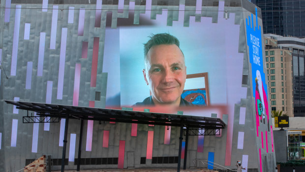 Federation Square CEO Xavier Csar projected on the screen of a deserted Fed Square. 