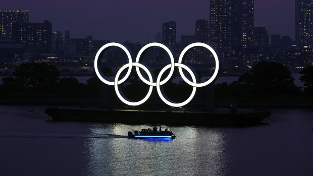 The Olympic rings float in the water at sunset in the Odaiba section in Tokyo.