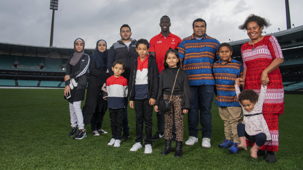 Welcome aboard: Sydney Swans star Aliir Aliir helped usher in these new Australian citizens, families who are originally from Iran and Fiji, at a ceremony at the SCG on Monday.