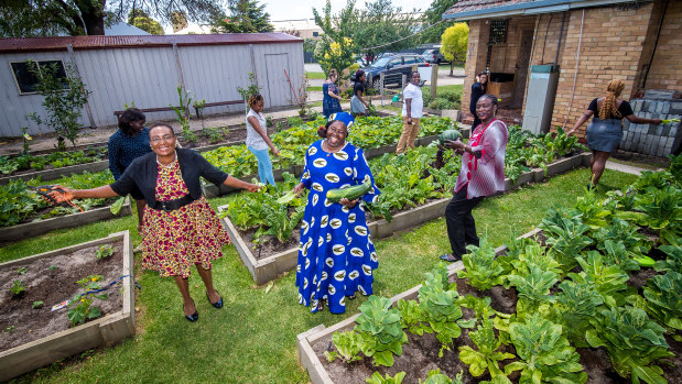 SelbaGondoza Luka, Rita Padang and Veronica Agobong with other community members in the community garden.