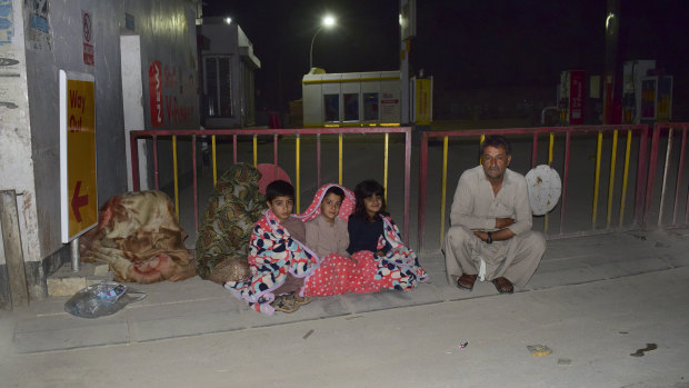 A Quetta family gathers outside the house following a severe earthquake that hit an area about 100km from the city on Thursday.