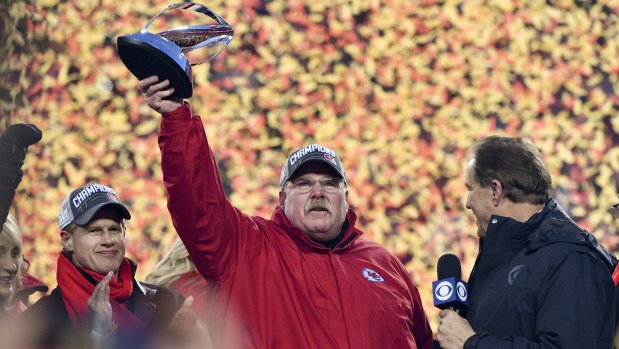 Reid holds up the Lamar Hunt Trophy after beating the Tennessee Titans to take out the AFC Championship.