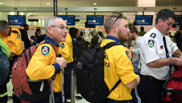 Australian fire specialists prepare to board a fight to California on Friday.