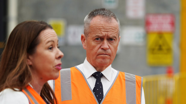Opposition Leader Bill Shorten, with Foodbank chief executive Brianna Casey, has promised to restore the charity's funding.