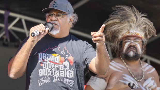 Senior spokesperson and cultural leader of the Wangan and Jagalingou Family Council Adrian Burragubba is seen on stage speaking at a NAIDOC event in South Brisbane on Friday.