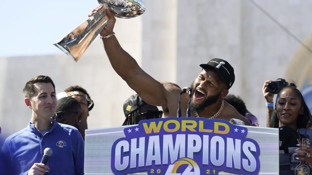 Shirt off, trophy up ... Aaron Donald holds the Vince Lombardi Trophy