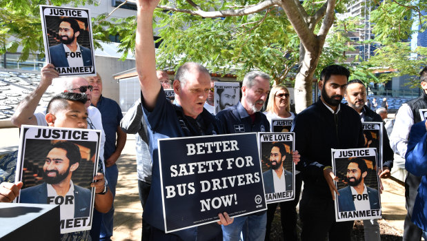 Tom Brown (centre) from the RTBU (Rail Tram and Bus Union), joins family and friends of slain bus driver Manmeet Alisher outside the Brisbane Supreme Court in Brisbane in August 2018.