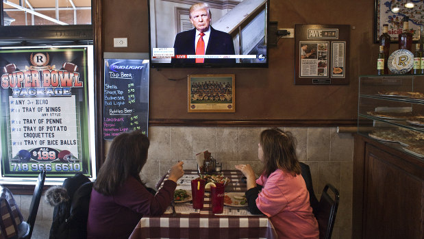 Customers watch television on the day of Donald Trump's presidential inauguration, at W’s Bar and Restaurant.  New York's 11th congressional district - which encompasses all of Staten Island and a slice of south Brooklyn - is the last remaining Republican-held seat in New York City.