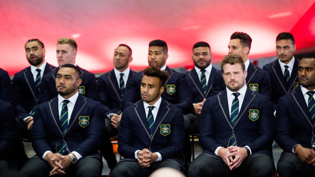 You're in: Petaia (back right) sits with Wallabies teammates at Friday's World Cup squad announcement at Sydney Airport. 