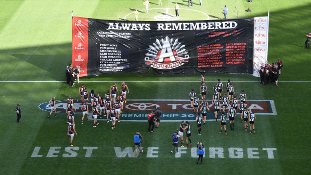 Players from both sides take part in an ANZAC Day ceremony last season.