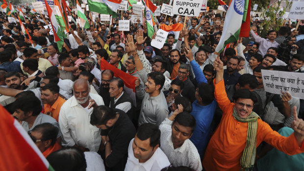 People rally in support of the new citizenship law near Gandhi Ashram in Ahmadabad, India.
