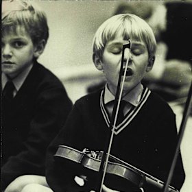 Richard Tognetti, aged six, at Pleasant Heights Public School, learnt violin by the Suzuki method. Here he is captured at a 1972 performance at the Conservatorium of Music.
