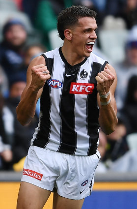 Ash Johnson celebrates after kicking a goal on his AFL debut against Adelaide.