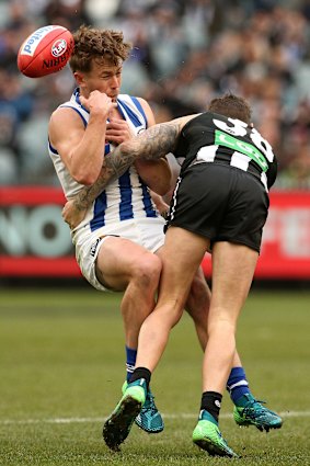 Hit hard: Trent Dumont is tackled by Jeremy Howe.