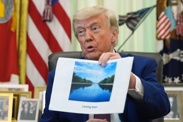President Donald Trump showing the media a render of the Reflecting Pool with its water coloured “American flag blue”.