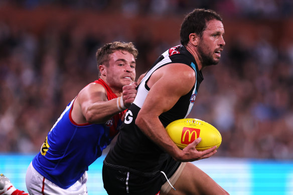 Kade Chandler of the Demons tackles Travis Boak of the Power.