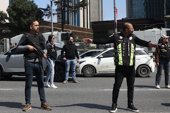 Police stand beside a cordoned off area outside a building in Istanbul.
