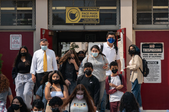 Students and staff exit Hollywood High School in Los Angeles. California is among states where infections in vaccinated people accounted for 12 to 24 per cent of COVID-related hospitalisations.