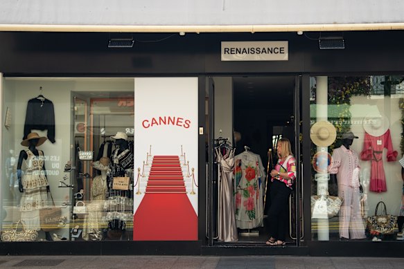 A shop worker stands at the door during the power outage.