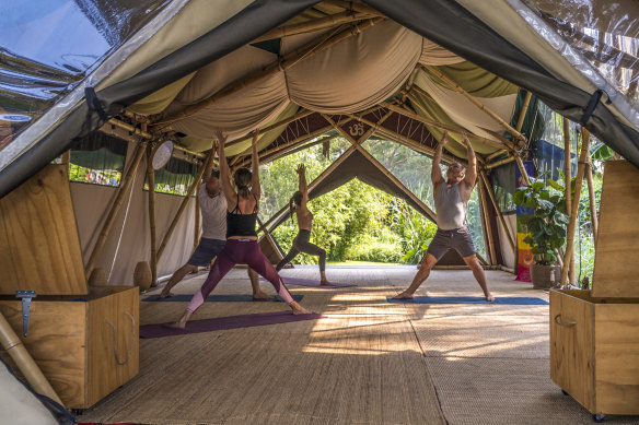 Strike a pose in a “tentple” at Bamboo Yoga School.