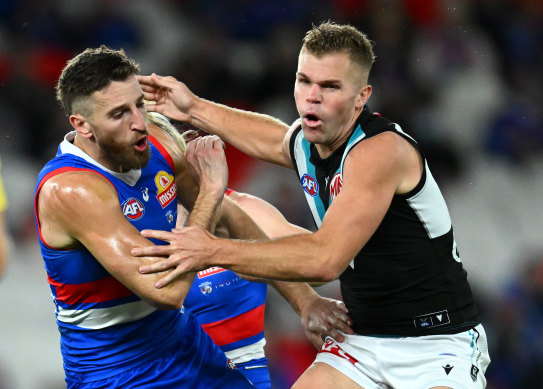 Marcus Bontempelli of the Bulldogs bumps Dan Houston of the Power.