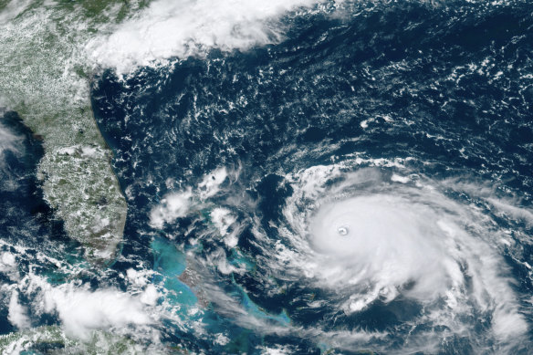 A satellite image of Hurricane Dorian as it bore down on the Bahamas on Saturday, local time. New projections show it is likely to curve upward enough to potentially spare Florida a direct hit.