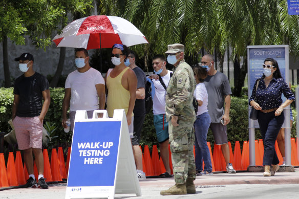 People line up at a COVID-19 testing site in Miami Beach, Florida, this week.