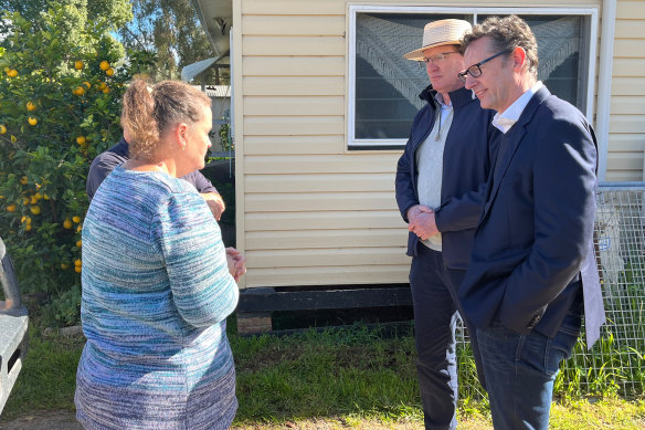 Federal Assistant Treasurer Stephen Jo<em></em>nes (right) and independent MP Andrew Gee speak to Lesley and Brian Smith outside their flood and storm-ravaged house in Eugowra.