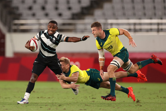 Waisea Nacuqu of Fiji is tackled by Australia’s Lachie Miller and Nick Malouf.