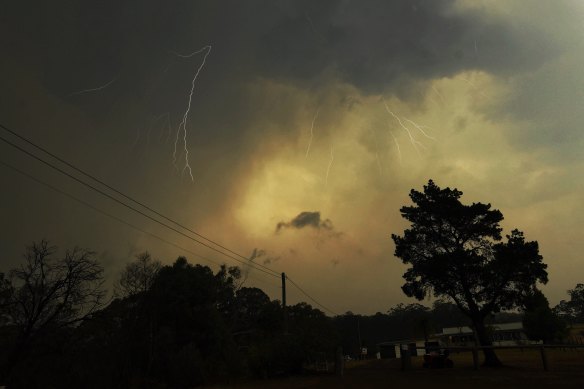 Lightning breaks through while bushfires rage nearby.