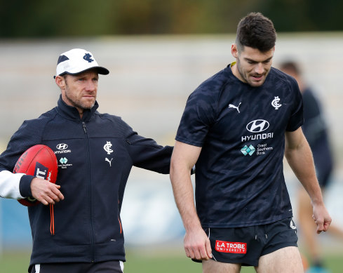 Carlton’s high-performance boss Andrew Russell with midfielder George Hewett (right).