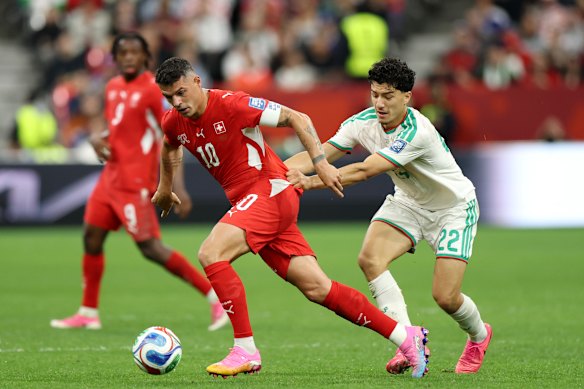 Granit Xhaka (10) of Switzerland is challenged by Ibrahim Maza (22) of Algeria.