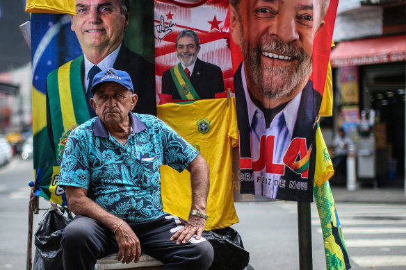 A street vendor in Sao Paulo with images of presidential candidates Lula da Silva and Jair Bolsonaro.