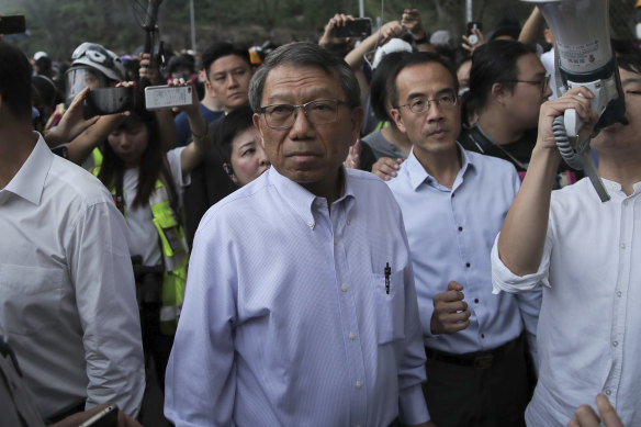 Professor Rocky Tuan, president of the Chinese University of Hong Kong, centre, arrives to negotiate with students and police.