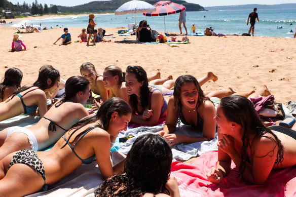 Beachgoers enjoy the warm weather at Palm Beach before the cold change on Friday.