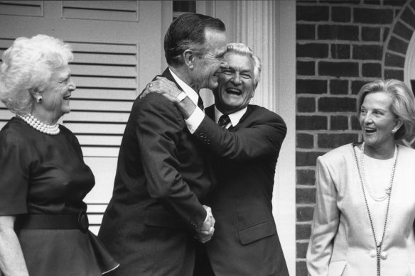 Former prime minister Bob Hawke embraces then US President George Bush snr as their wives Hazel Hawke (right) and Barbara Bush look on in Canberra in January 1992.