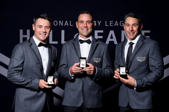 Cooper Cronk, Cameron Smith and Billy Slater pose with their Hall of Fame rings and blazers.