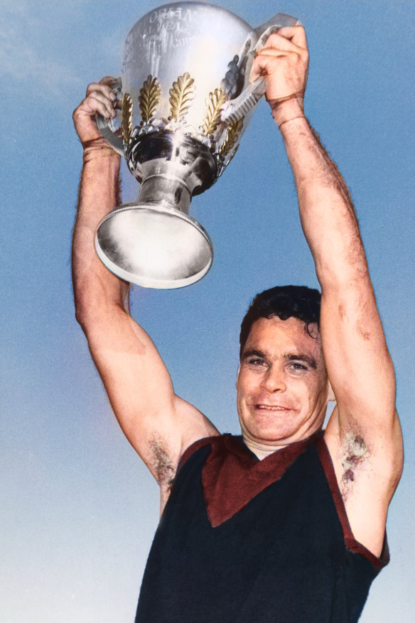Melbourne captain Ron Barassi holds up the 1964 VFL premiership cup.