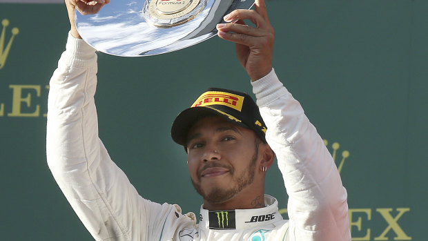 Mercedes driver Lewis Hamilton lifts his trophy for second place.