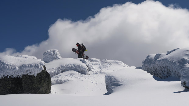 A snowboarder ascending Mount Tate in the Snowy Mountains.