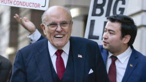 Former mayor of New York Rudy Giuliani walks to speak to the media outside the federal courthouse in Washington.
