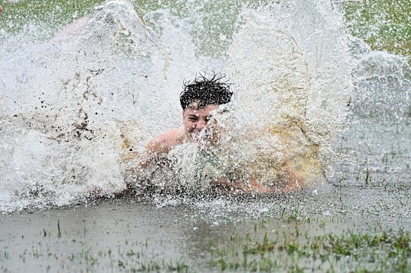 Boys make the most of a flooded park in Rosalie in Brisbane’s inner west.
