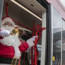 Santa enjoys a 'smooth' ride on the tram to deliver presents