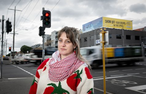 West Melbourne resident Beck Roy at the pedestrian crossing over Dynon Road, which will be removed to speed up traffic coming off the West Gate Tunnel. 
