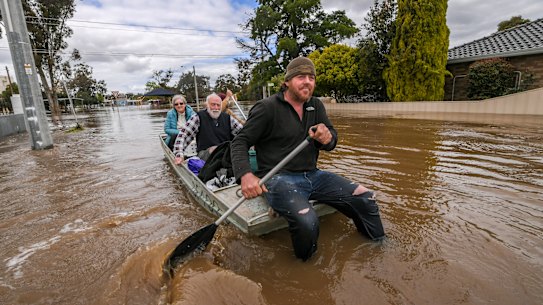 Tom Collins and mate Tim Tyler rescuing Max and Julia Hastilow from their Rochester home.
