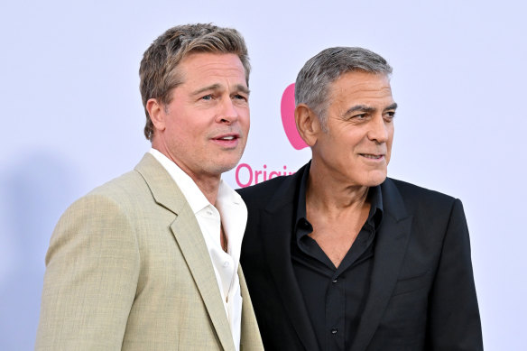 Brad Pitt and George Clooney clean shaven at the Venice Film Festival red carpet.