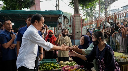 Indonesian President Joko Widodo greets people at Pal Merah traditional market, in Jakarta, Indonesia on June 26, 2023.